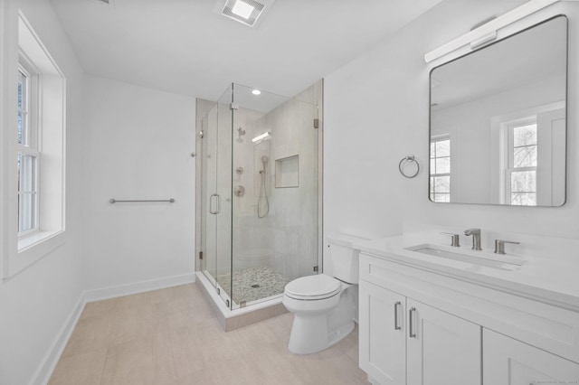 bathroom featuring an enclosed shower, vanity, and toilet