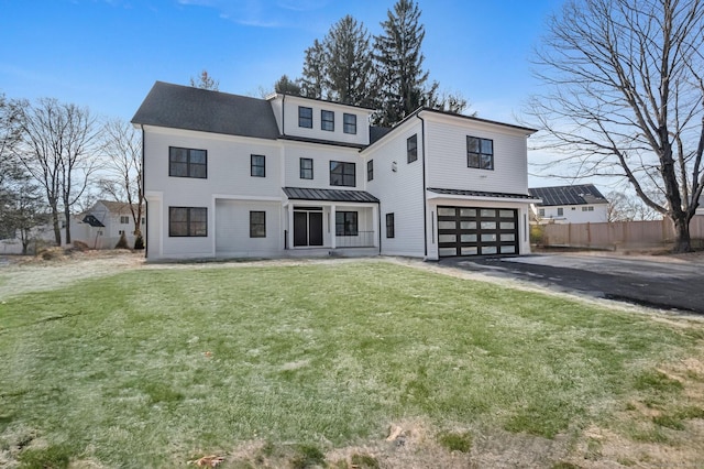 view of front of property featuring a garage and a front yard