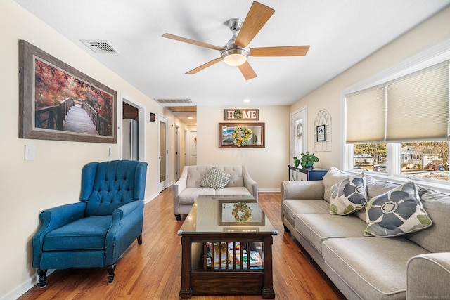 living room with hardwood / wood-style flooring and ceiling fan