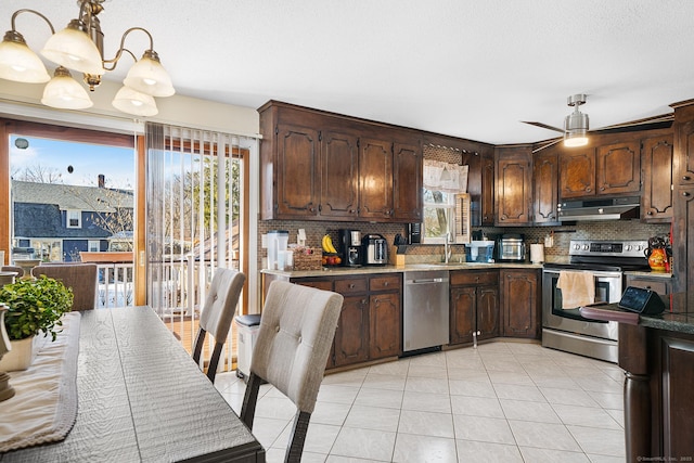 kitchen with sink, decorative light fixtures, dark brown cabinets, stainless steel appliances, and decorative backsplash