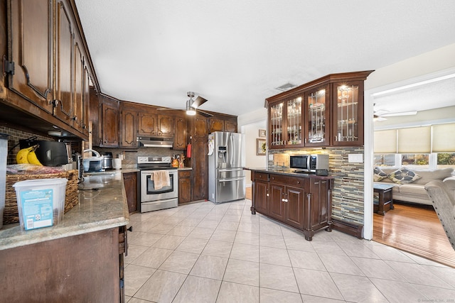 kitchen with ceiling fan, appliances with stainless steel finishes, and dark brown cabinets