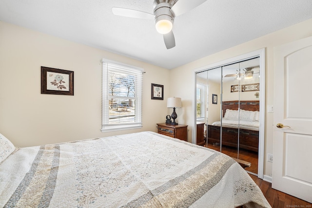 bedroom featuring dark wood-type flooring, ceiling fan, and a closet