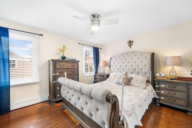 bedroom with ceiling fan, dark hardwood / wood-style flooring, and a baseboard heating unit