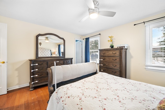 bedroom with ceiling fan and light wood-type flooring