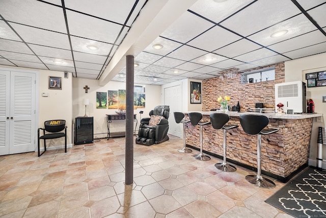 bar with plenty of natural light and a paneled ceiling