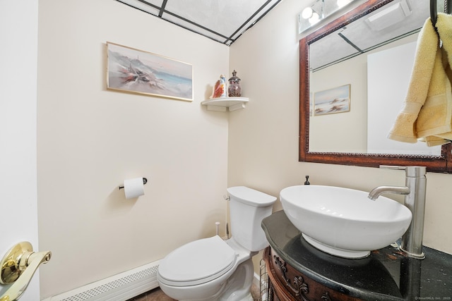 bathroom with vanity, toilet, and baseboard heating