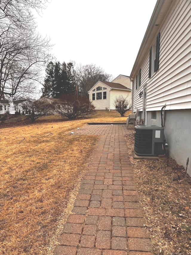 view of yard with central AC and a patio area