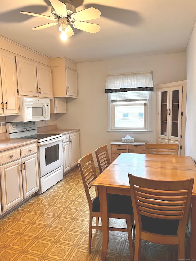 kitchen featuring ceiling fan, white cabinets, and white appliances