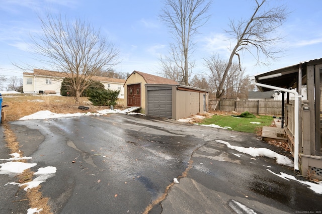 exterior space featuring a garage and an outdoor structure