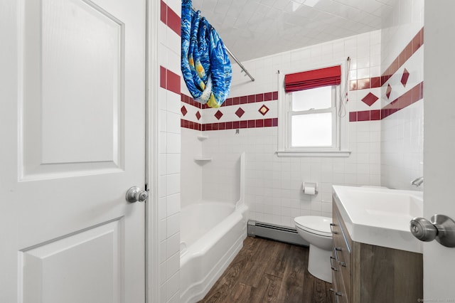 full bathroom with toilet, baseboard heating, vanity, tiled shower / bath combo, and hardwood / wood-style flooring