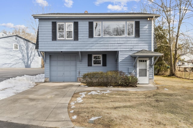 view of front property featuring a garage and a front lawn