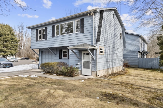 view of front of home featuring a garage and fence