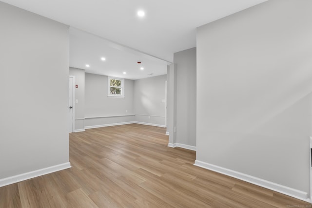 empty room with recessed lighting, baseboards, and light wood-type flooring