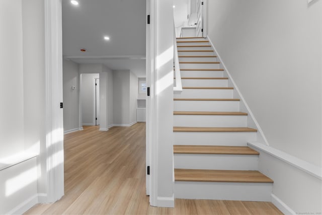 stairs featuring recessed lighting, baseboards, and wood finished floors