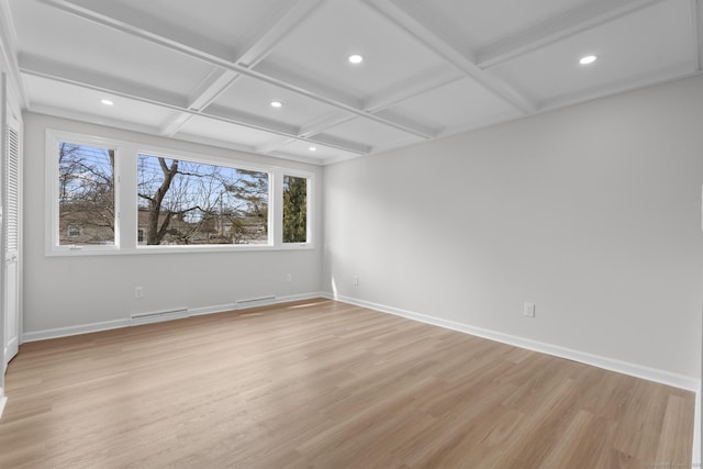 unfurnished room featuring visible vents, baseboards, beam ceiling, light wood-style flooring, and coffered ceiling