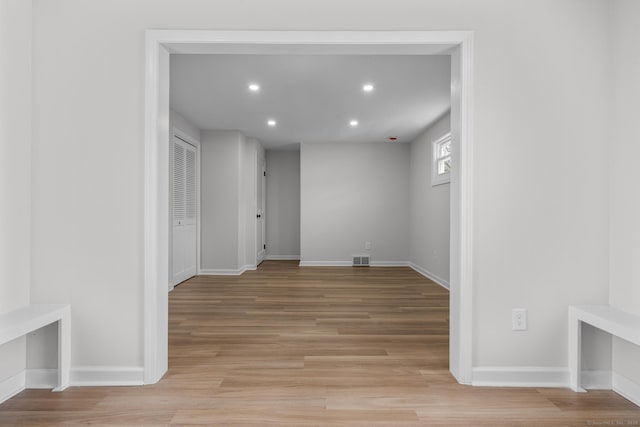 unfurnished room featuring visible vents, recessed lighting, light wood-type flooring, and baseboards