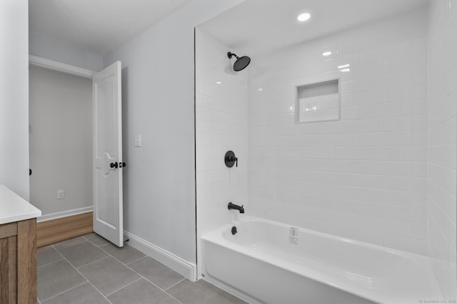 bathroom featuring tile patterned floors, shower / bath combination, baseboards, and vanity