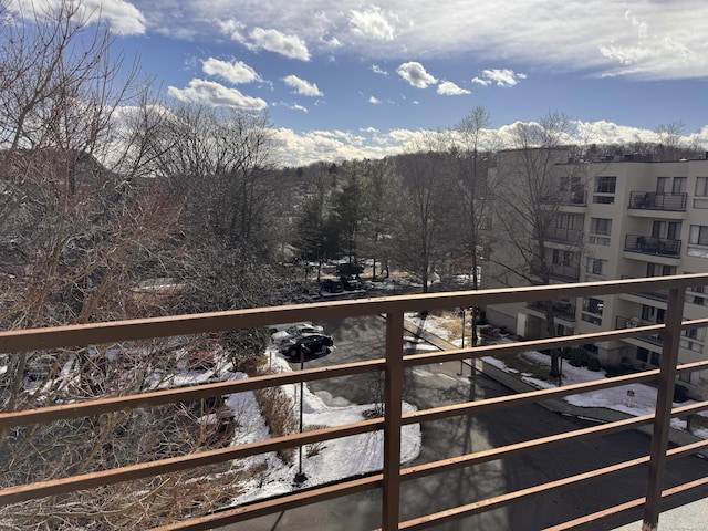 view of snow covered back of property