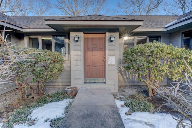 view of snow covered property entrance