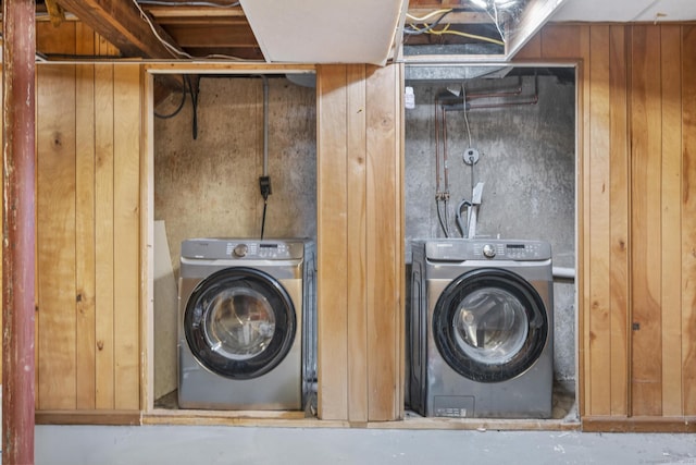 laundry area featuring washer / dryer and wood walls