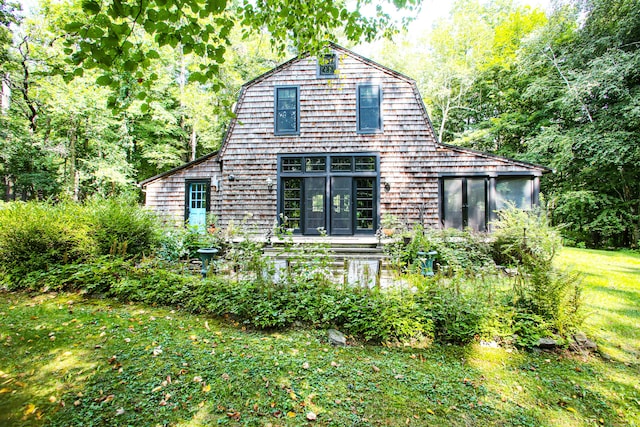 rear view of house featuring a lawn