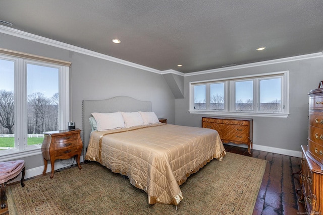 bedroom featuring ornamental molding, dark hardwood / wood-style floors, and a textured ceiling