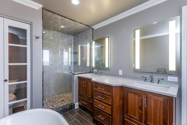 bathroom with vanity, ornamental molding, and separate shower and tub