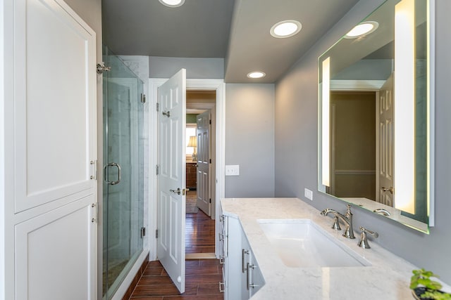 bathroom featuring vanity, hardwood / wood-style floors, and an enclosed shower