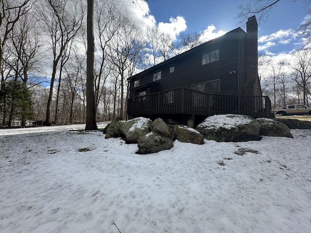 snow covered house with a deck