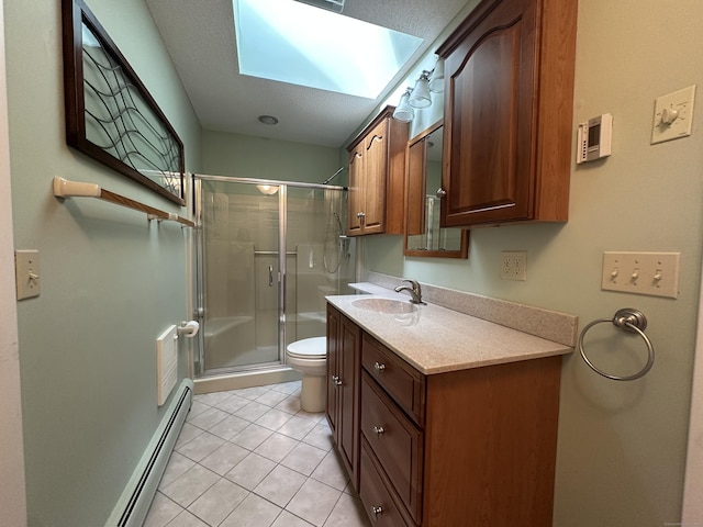 bathroom with a skylight, a baseboard radiator, vanity, walk in shower, and toilet