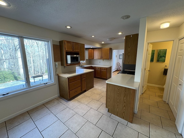 kitchen featuring light tile patterned floors and a textured ceiling