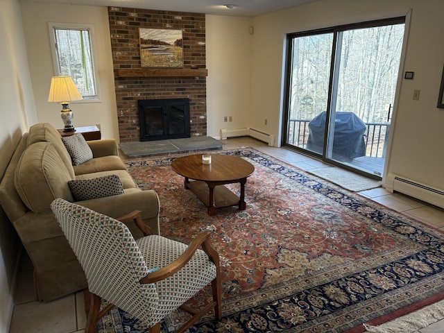 living room with a baseboard heating unit, light tile patterned floors, a wealth of natural light, and a fireplace