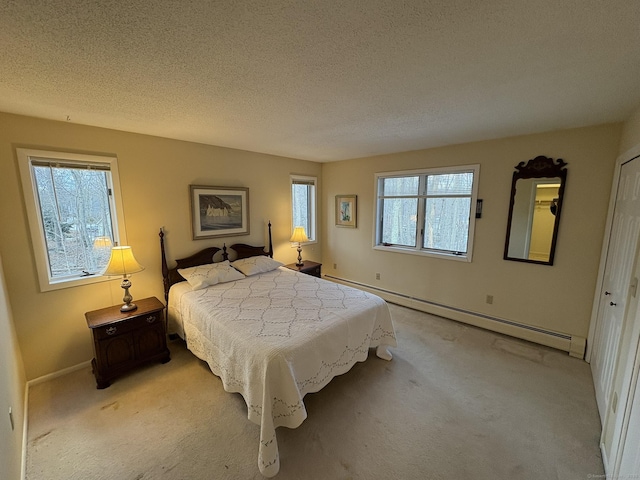 carpeted bedroom featuring a textured ceiling and a baseboard heating unit