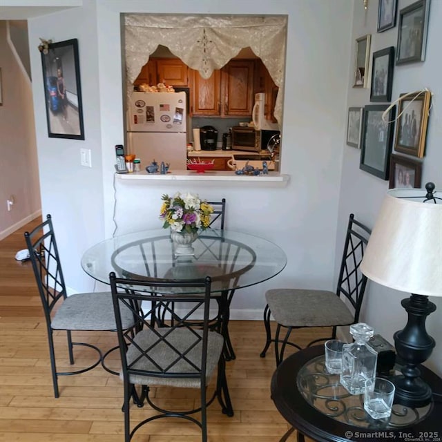 dining space featuring light wood-type flooring