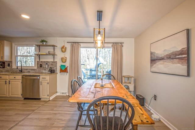 dining space with sink and light hardwood / wood-style flooring