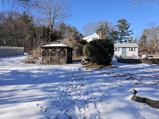 yard covered in snow with a gazebo