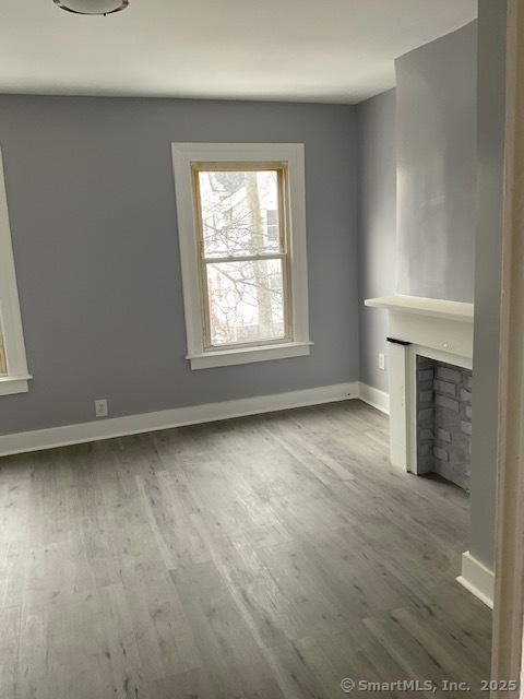 unfurnished living room with wood-type flooring