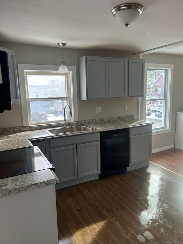 kitchen with gray cabinets, decorative light fixtures, dishwasher, sink, and dark wood-type flooring