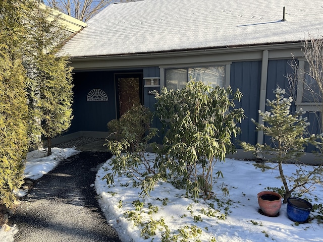 view of snow covered property entrance