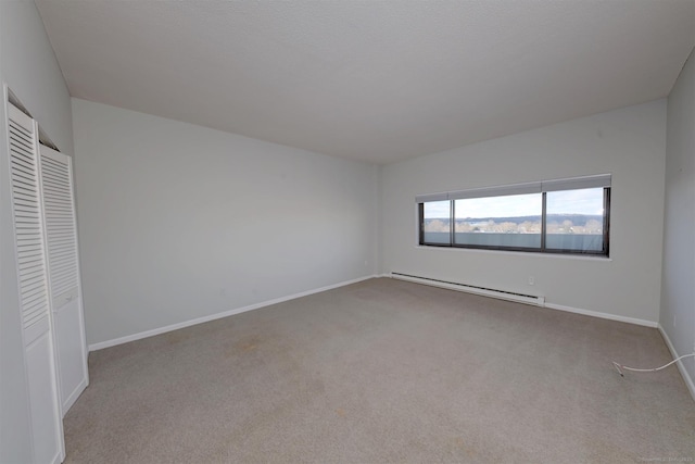 interior space featuring light carpet, baseboard heating, and a closet