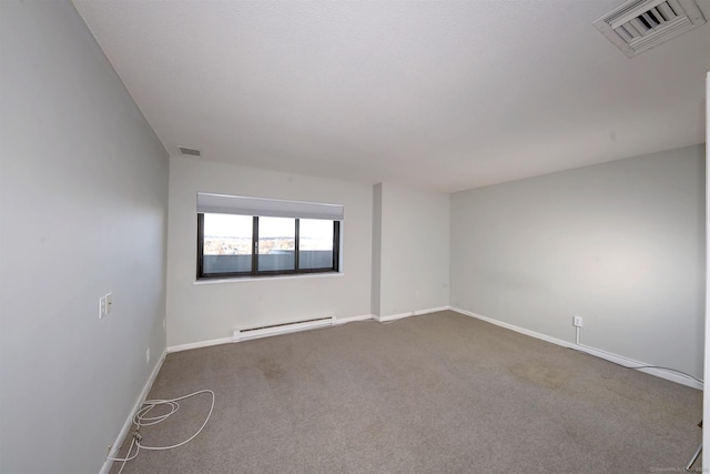 empty room featuring carpet floors and a baseboard heating unit