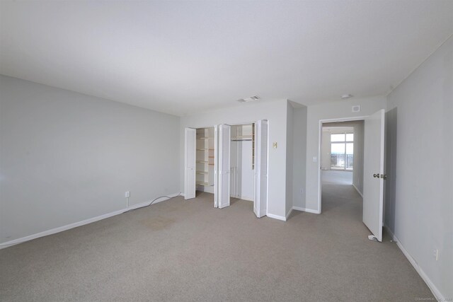 unfurnished bedroom featuring light carpet