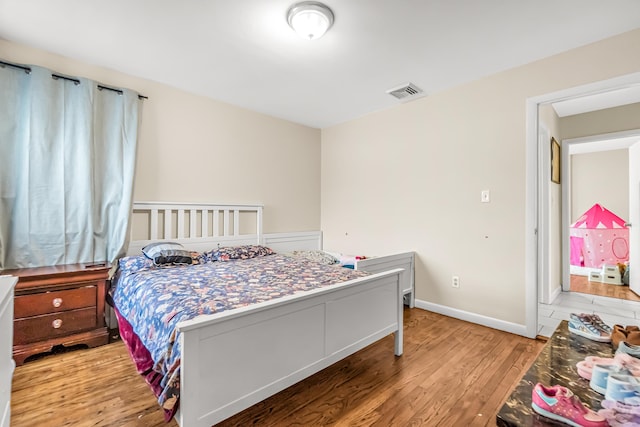 bedroom with light hardwood / wood-style flooring