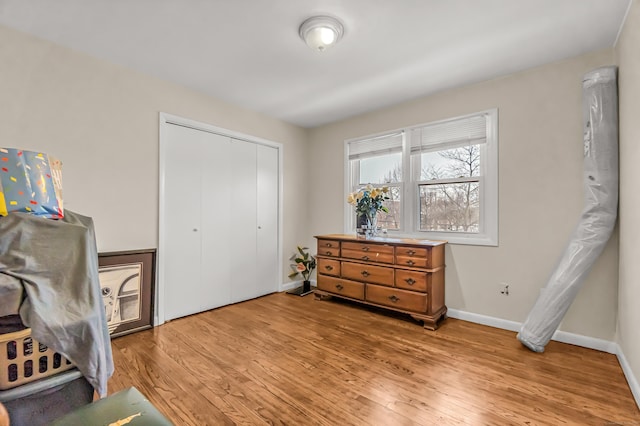 bedroom featuring light hardwood / wood-style floors and a closet