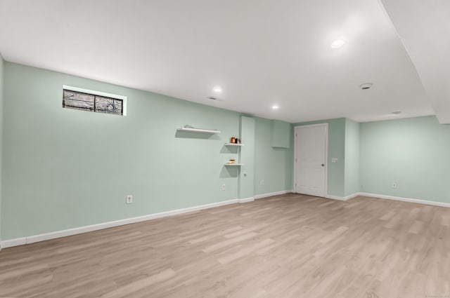 basement with light hardwood / wood-style floors