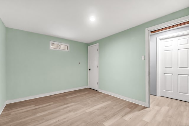 unfurnished bedroom with light wood-type flooring