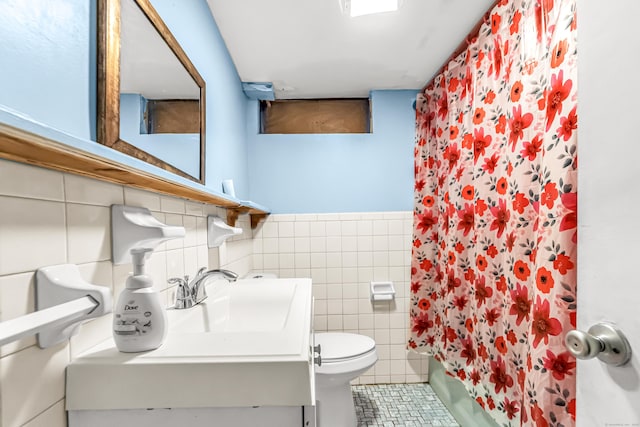 full bathroom featuring shower / tub combo, tile walls, vanity, tile patterned floors, and toilet