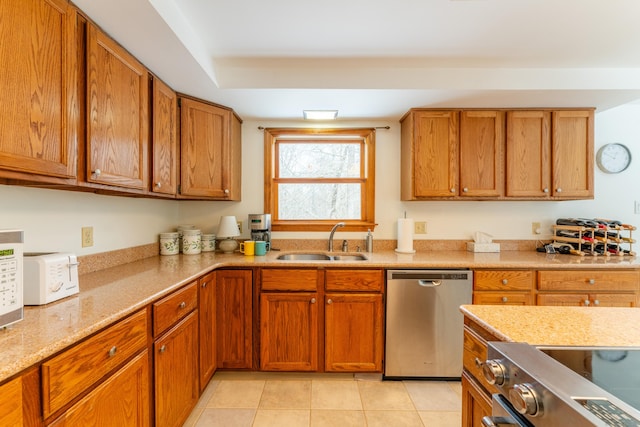 kitchen featuring dishwasher, sink, stove, light tile patterned floors, and light stone counters