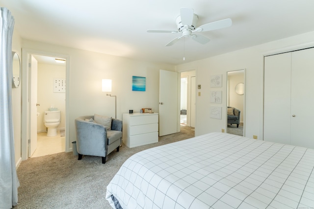 bedroom with connected bathroom, light colored carpet, ceiling fan, and a closet