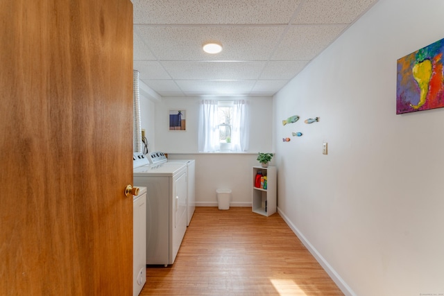 laundry area featuring washer and clothes dryer and light wood-type flooring